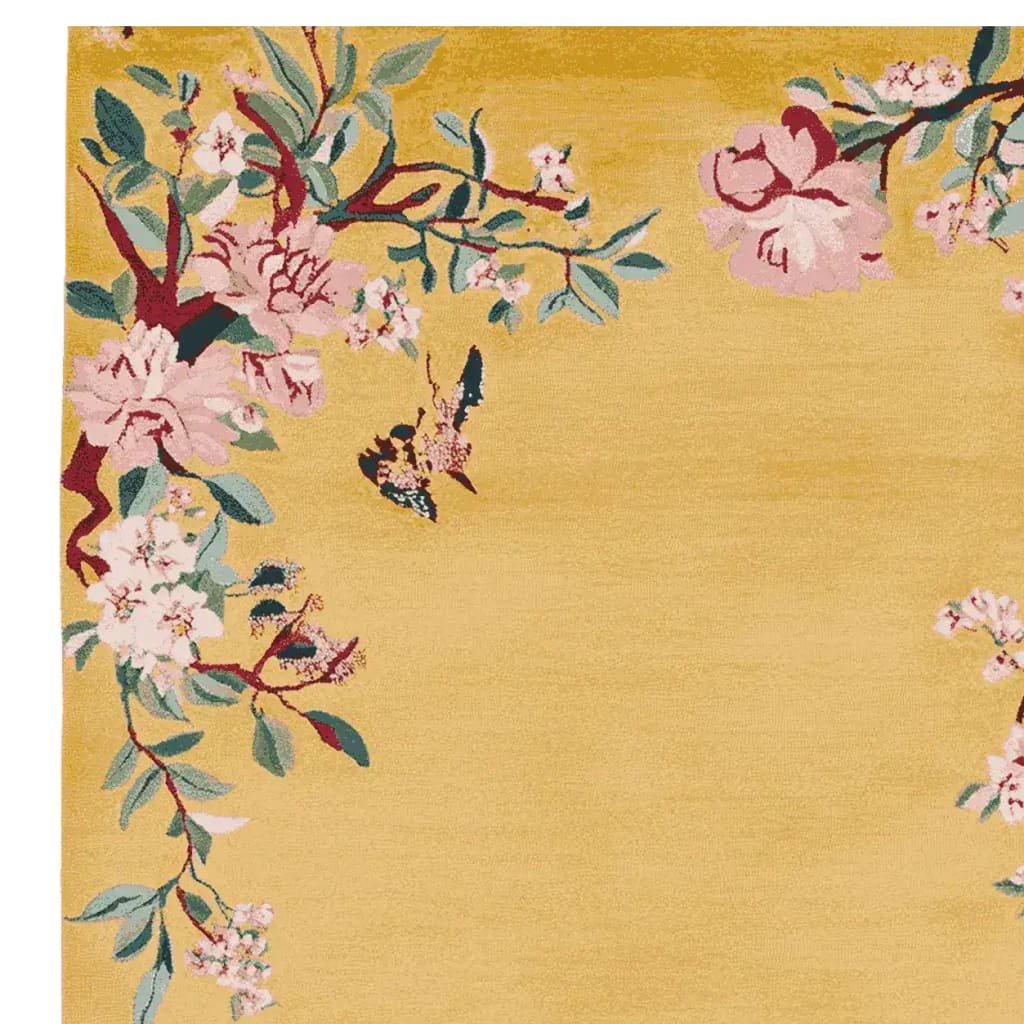 A beautiful hand-tufted area rug featuring a vibrant golden background with an intricate floral design in pink and green hues. This wool rug is perfect for adding a touch of elegance to living room area rugs, making it a standout piece among rugs for living room decor.