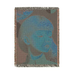 Golden Gaze Surreal Portrait woven blanket back view, tonal blue monochrome child face with fish motif on grey-brown woven ground and fringe