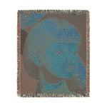 Golden Gaze Surreal Portrait woven blanket reverse, faded blue-toned monochrome portrait of child on grey-brown fabric with fringe edge