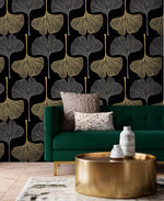 Golden Gingko Grove Wallpaper in black and gold behind an emerald sofa and brass table