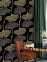 Golden Gingko Grove Wallpaper of gold and grey leaves on black with rust chair and green drape