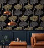 Golden Gingko Grove Wallpaper on black with copper pendants above a tan leather ottoman