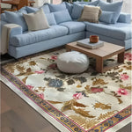 A beautifully designed Golden Glory Square Hand Tufted Wool Rug graces the floor of a cozy living room. The square area rug features an elegant floral pattern with vibrant colors, making it a perfect choice for bedrooms or large living rooms. The wool rug complements the light blue sectional sofa, creating a warm and inviting atmosphere, ideal for area rugs in living rooms.