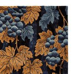 A close-up view of the Golden Harvest Hand Tufted Area Rug, showcasing intricate grapevine patterns in rich blue and gold hues. This luxurious wool rug is perfect as a living room rug, measuring 8x10, adding a touch of vintage elegance to any space.