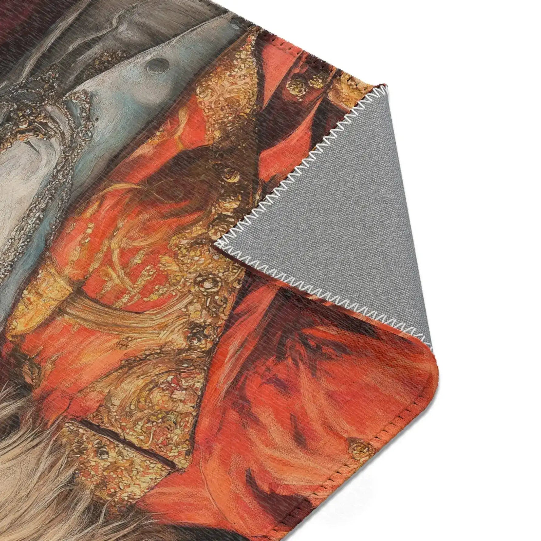 Close-up corner fold showing grey backing and bold red baroque embroidered jacket section of the Golden Majesty Luxe Lion Accent Rug