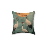 Square throw pillow with teal-blue distressed background showing three white Japanese cranes with red-capped heads beneath a large golden moon — Golden Moon & Crane Serenity Pillow front