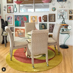 A stylish room featuring a Golden Orange Geometry Round Hand Knotted Wool Rug, perfect for adding warmth and elegance to any bedroom or living room. The area rug complements the room's eclectic decor with its vibrant colors and unique design, making it an ideal choice for bedroom rugs or area rugs for the living room.