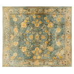 Elegant Golden Petals Hand Tufted Wool Rug featuring intricate floral designs in warm golden hues on a soothing blue background. This vintage-inspired area rug is perfect for adding a touch of sophistication to your living room decor. Ideal as a living room rug in an 8x10 size, it combines traditional craftsmanship with modern elegance, making it a standout piece for any home.