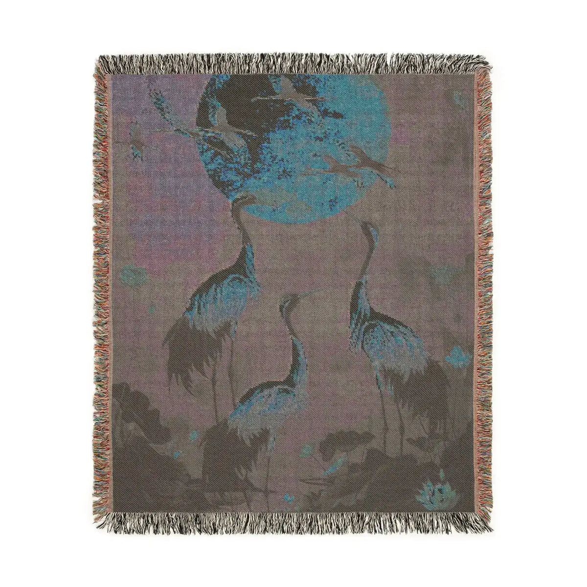 Golden Serenity woven blanket corner folded back showing large orange and pink cosmos flowers on dark navy, grey backing visible