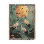 Golden Serenity woven blanket with dark navy ground, scattered orange and purple wildflowers, blue foliage, vertical format