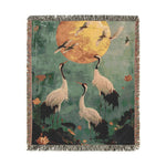Golden Serenity Cranes at Dusk Woven Blanket full view showing white cranes and golden moon on deep green ground with fringe edge