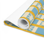 Rolled-up Golden Solstice yoga mat close-up, blue and cream star-check print with gold accents