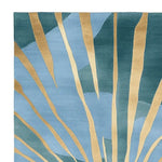Close-up view of the Golden Sunrise Hand Tufted Rug, featuring an abstract design with golden sunray patterns on a soothing blend of blue and green. This contemporary wool area rug is perfect for adding a stylish touch to large living room spaces, making it an ideal choice for those seeking modern rugs for living room decor.