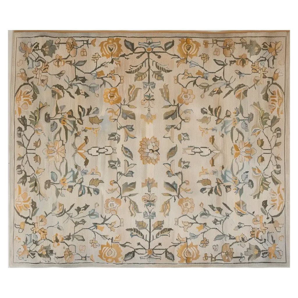 This image showcases a luxurious area rug, the Golden Timeless Harmony Hand Tufted Wool Rug, featuring an intricate floral pattern in calming earth tones. Perfect for large living room spaces, this vintage rug design adds elegance and warmth.