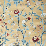 Elegant Golden Vine Rhapsody Hand Tufted Area Rug showcasing intricate floral patterns with blue, red, and white flowers on a soft golden wool background. Perfect for adding a touch of nature to large living room spaces, this wool rug blends artistic design with comfort.