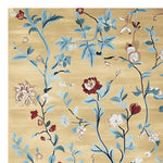 This elegant area rug, titled 'Golden Vine Rhapsody Hand Tufted Rug', showcases a beautiful floral design with blue and red blossoms on a warm golden background. Perfect as a wool rug for your living room, this large living room rug adds a touch of sophistication and warmth to any space.