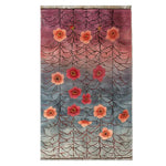 The Gossamer Dawn Knotted Wool Rug is a stunning area rug perfect for enhancing living room decor. Featuring a beautiful gradient from pink to blue, this wool rug showcases an abstract floral pattern with vibrant red and orange flowers, making it a standout piece among rugs for living room spaces.