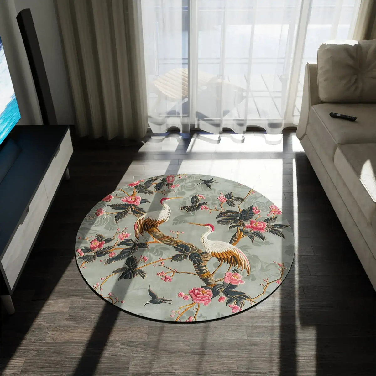 Graceful Crane and Blossom Round Rug at an angle in a softly lit room, sage-green crane and pink blossom print visible