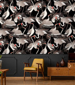 Graceful Crane Haven Wallpaper in black with grey cranes over a tan ottoman and credenza