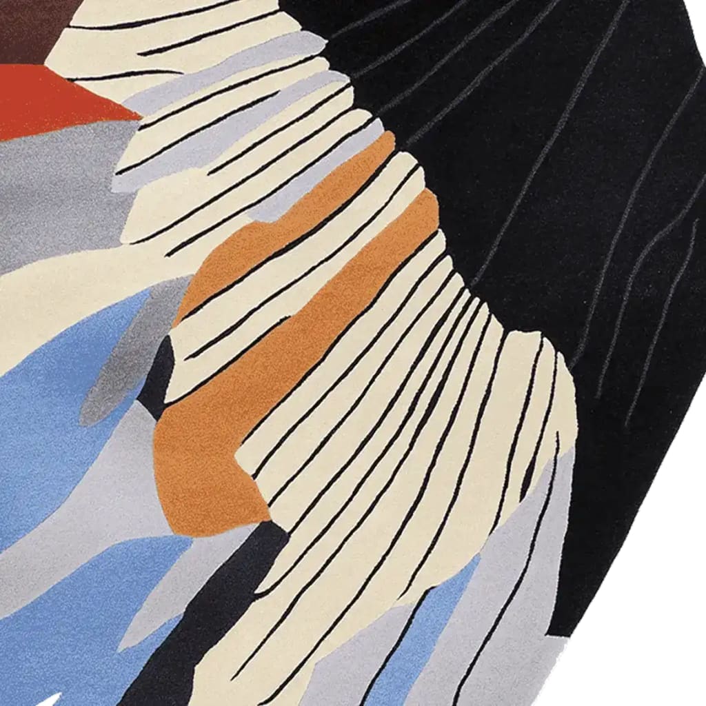 Close-up view of a Graphic Wing Flow Hand Tufted Area Rug showcasing its abstract design with bold colors and intricate patterns, perfect for adding a contemporary touch to any living room. This wool rug features a harmonious blend of orange, blue, and beige hues, ideal as a large living room rug.
