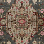 Close-up view of the Gray Medallion Elegance Hand Knotted Area Rug, showcasing intricate floral and vintage Persian-inspired patterns. Perfect for adding a touch of sophistication to large living rooms, this rug features a harmonious blend of colors and detailed medallion design.