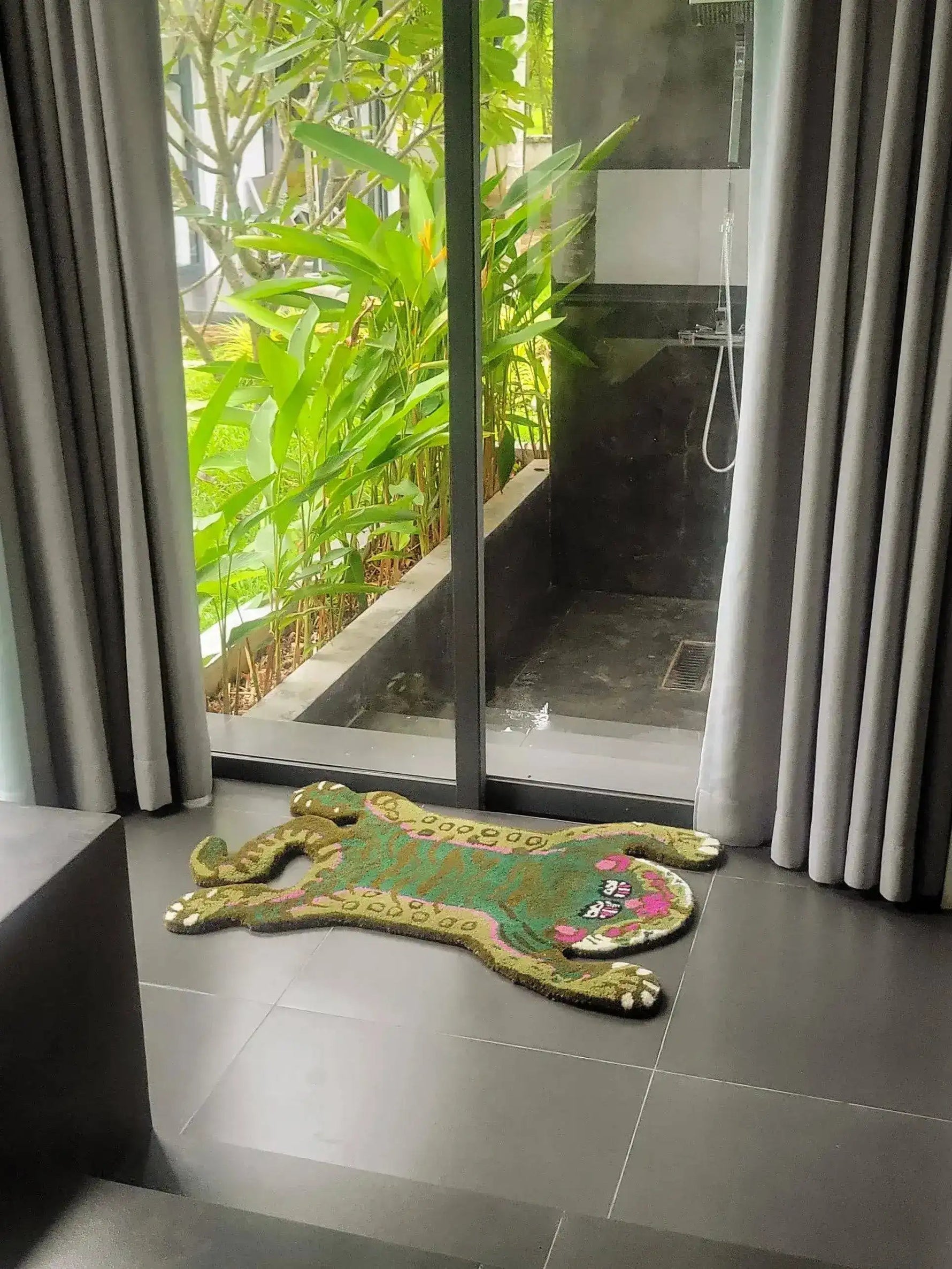 Stylish Green Asian Tiger Wool Rug on sleek gray tile floor, adding a touch of vintage charm to a dining room or office space. This area rug, with its abstract tiger design, complements formal dining room settings and dining room carpets perfectly.