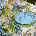 green essence placemat outdoor table with blue lattice plate green napkin wicker dragonfly ring and wicker palm centerpiece