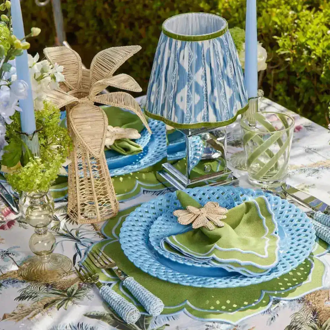 green essence placemat scalloped green and white outdoor table blue lattice plates green napkin blue ikat lamp and candles
