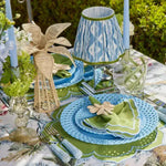 green essence placemat scalloped green and white outdoor table blue lattice plates green napkin blue ikat lamp and candles