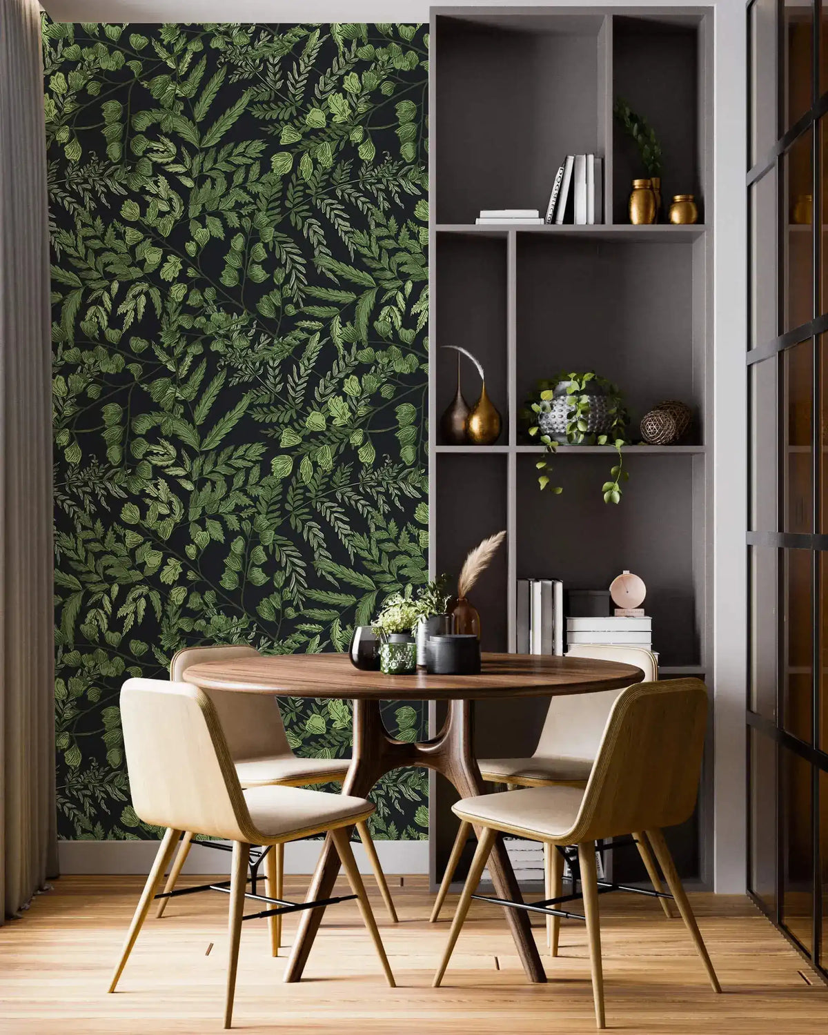 Green fern foliage wallpaper on dark ground in a dining nook with round table, chairs and grey shelving