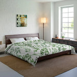 Green Foliage Comforter with scattered green leaf print on a dark walnut bed in a bright minimalist bedroom
