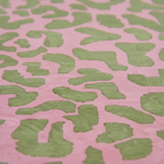 Pink close up tufted rug shot with green leaf pattern