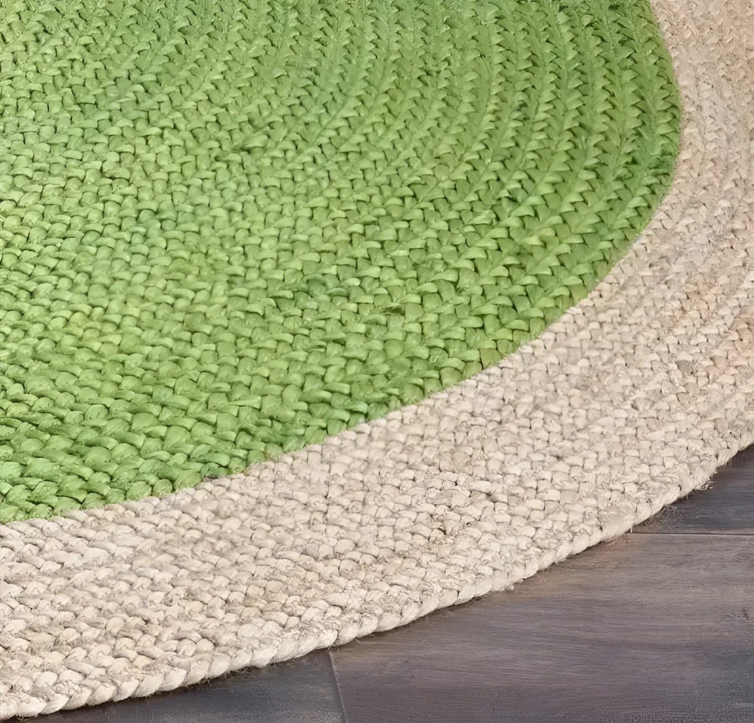 Close-up of the green braided field meeting the chunky natural beige border of the round jute rug