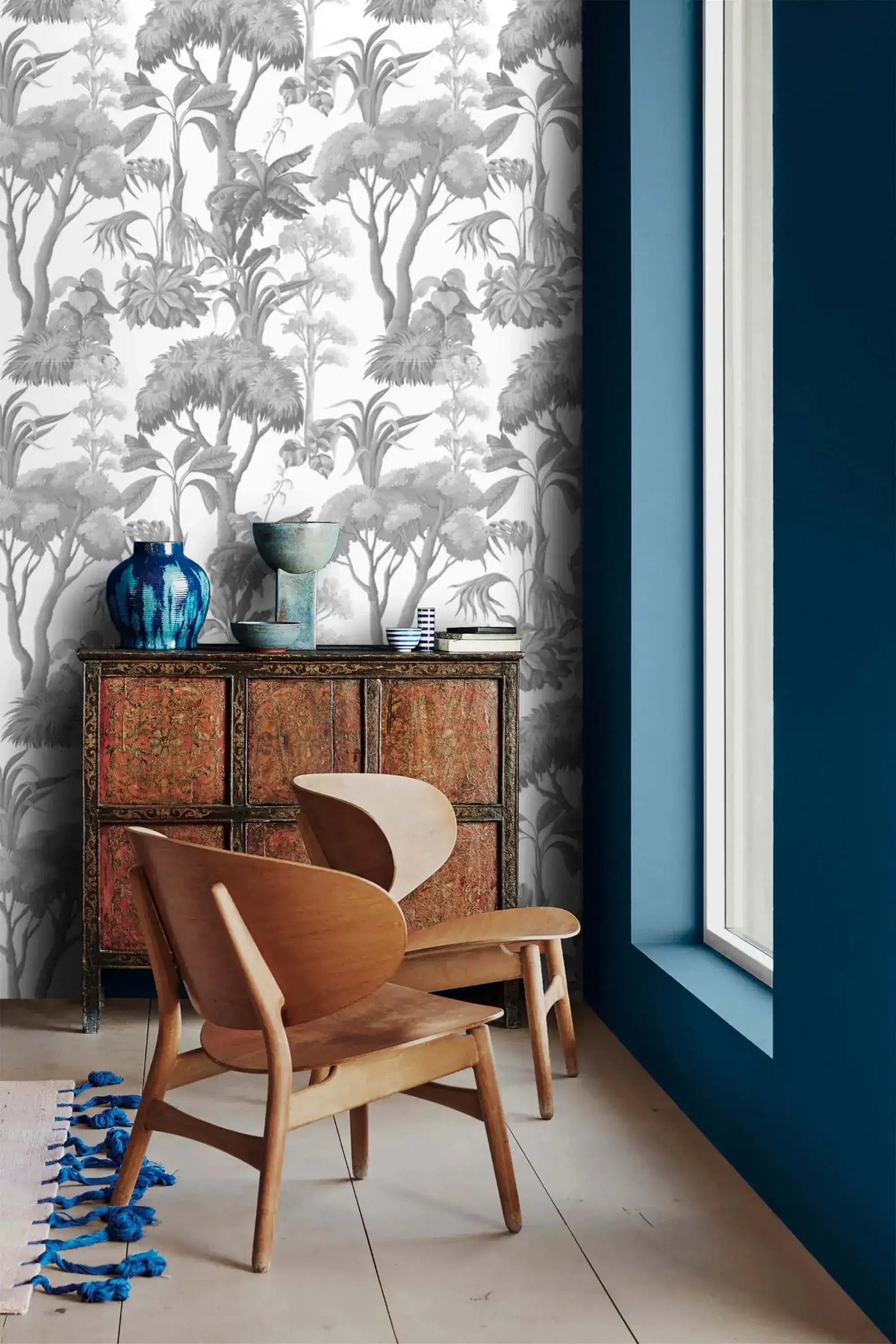 Grey Forest Serenity Wallpaper above an ornate red cabinet and pair of wood chairs