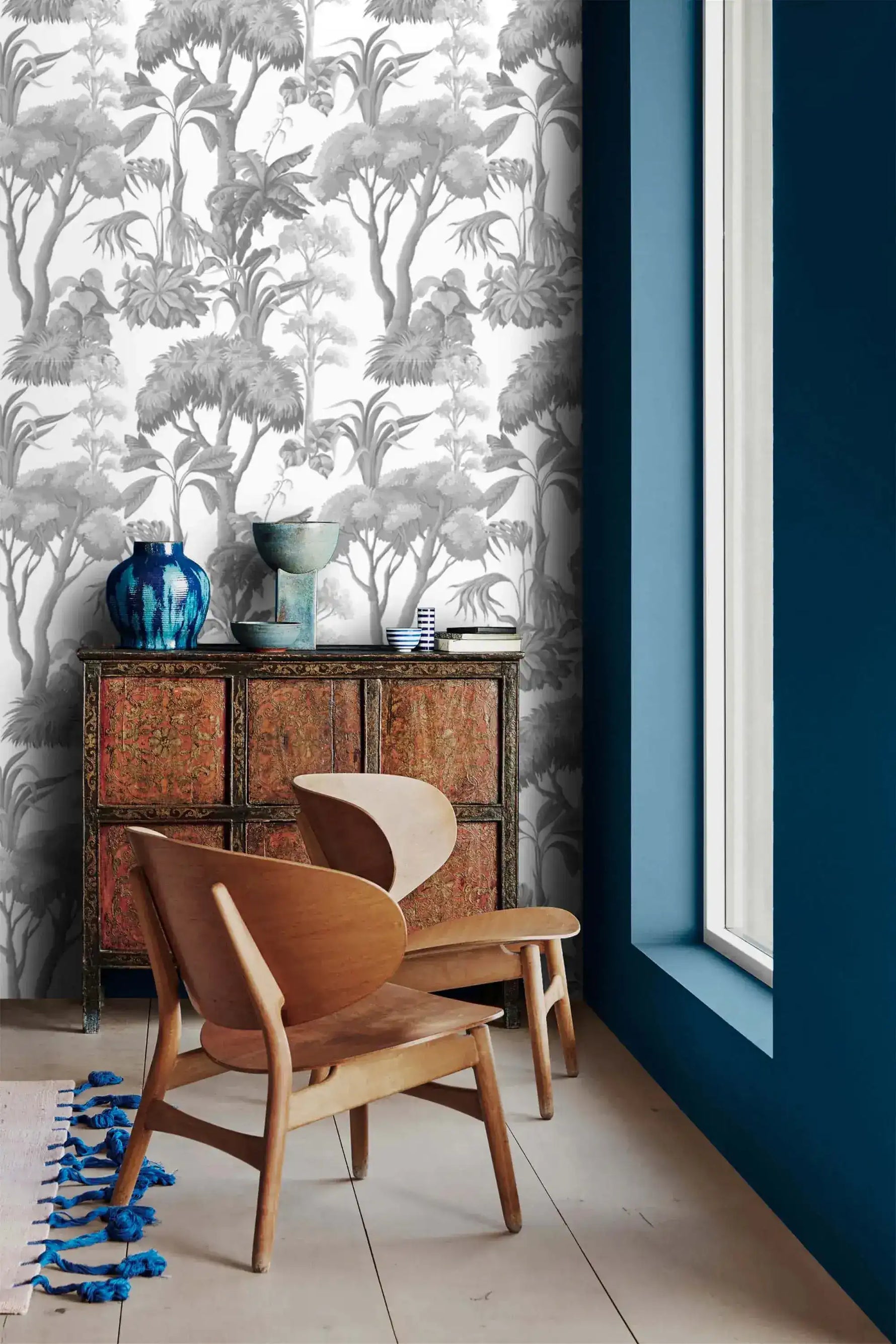 Grey Forest Serenity Wallpaper above an ornate red cabinet and pair of wood chairs