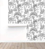 Grey Forest Serenity Wallpaper partly hung beside a white roll on a wood floor