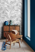 Grey Tropical Foliage Wallpaper above an ornate red cabinet and pair of wood chairs