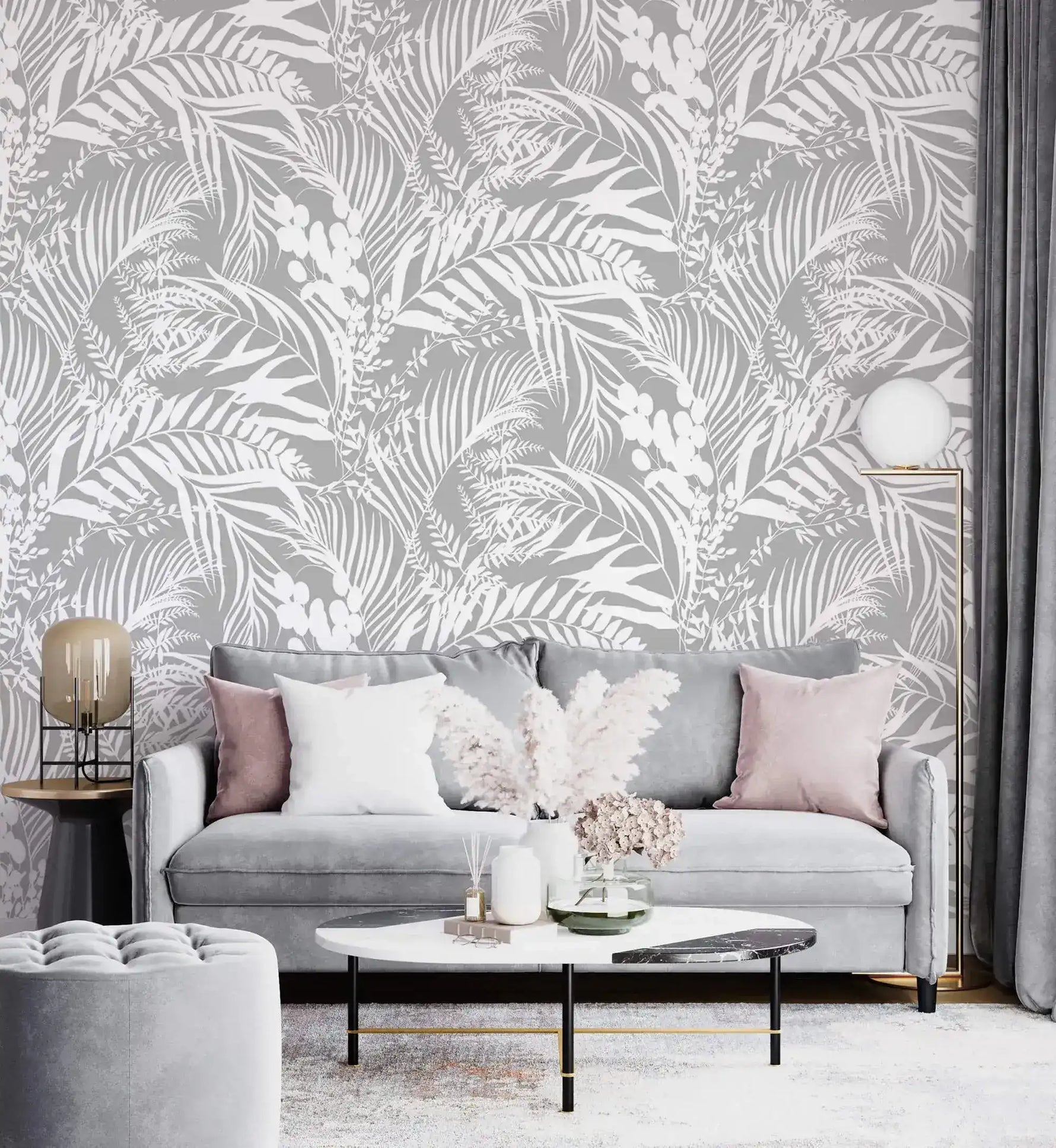 Grey Tropical Foliage Wallpaper of white ferns on grey behind a grey sofa with pink cushions