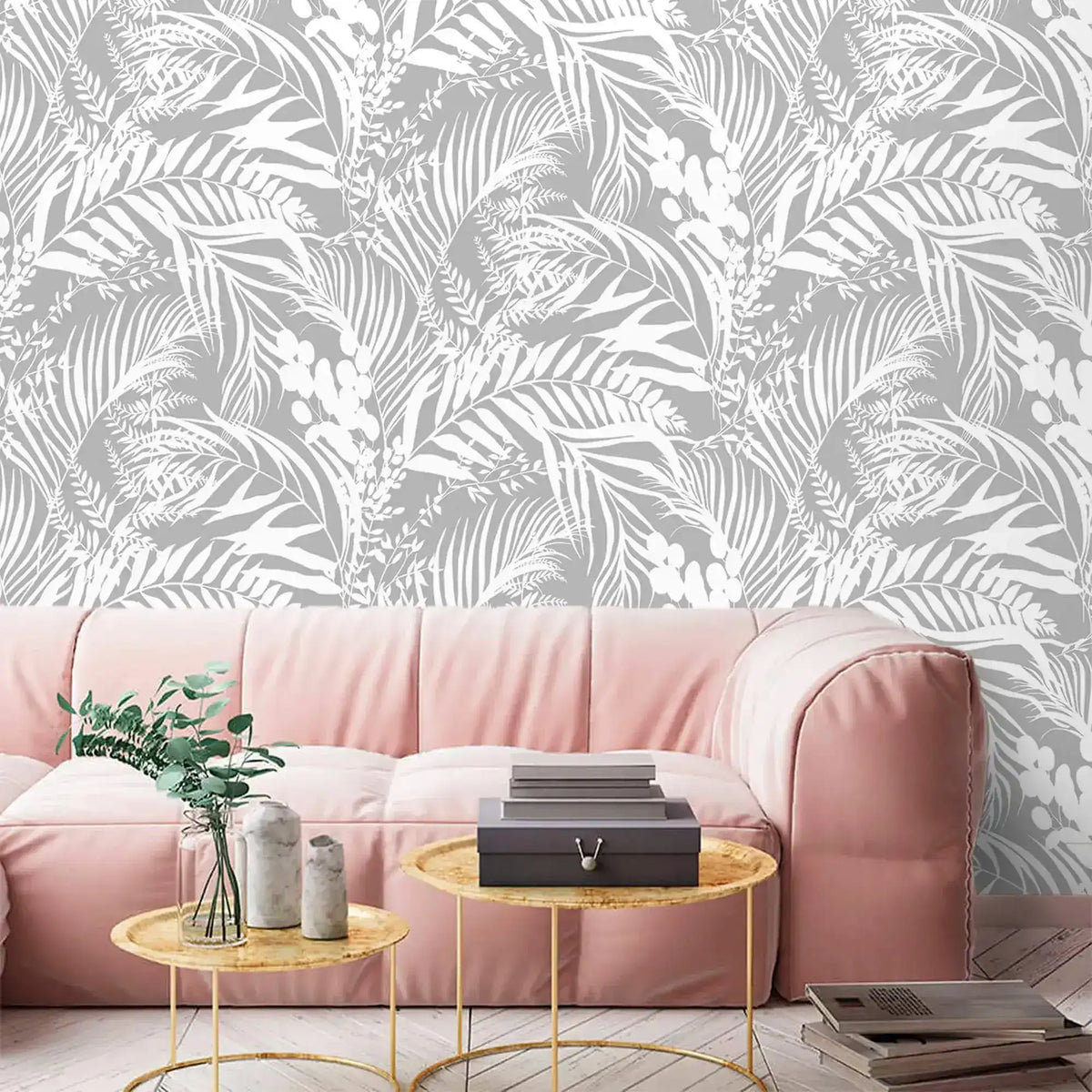 Grey Tropical Foliage Wallpaper of white leaves on grey behind a soft pink sofa