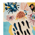 Close-up view of a vibrant Groovy Garden Forms Hand Tufted Area Rug, showcasing abstract floral patterns in blue, yellow, and pink. This contemporary wool rug is perfect for adding a splash of color to any living room. Ideal as an 8x10 area rug for modern interiors.