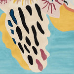 A vibrant, abstract design on an area rug, showcasing a mix of black, blue, yellow, and pink hues against a light blue background. This wool rug is perfect for adding a contemporary touch to living room spaces, particularly in an 8x10 size.