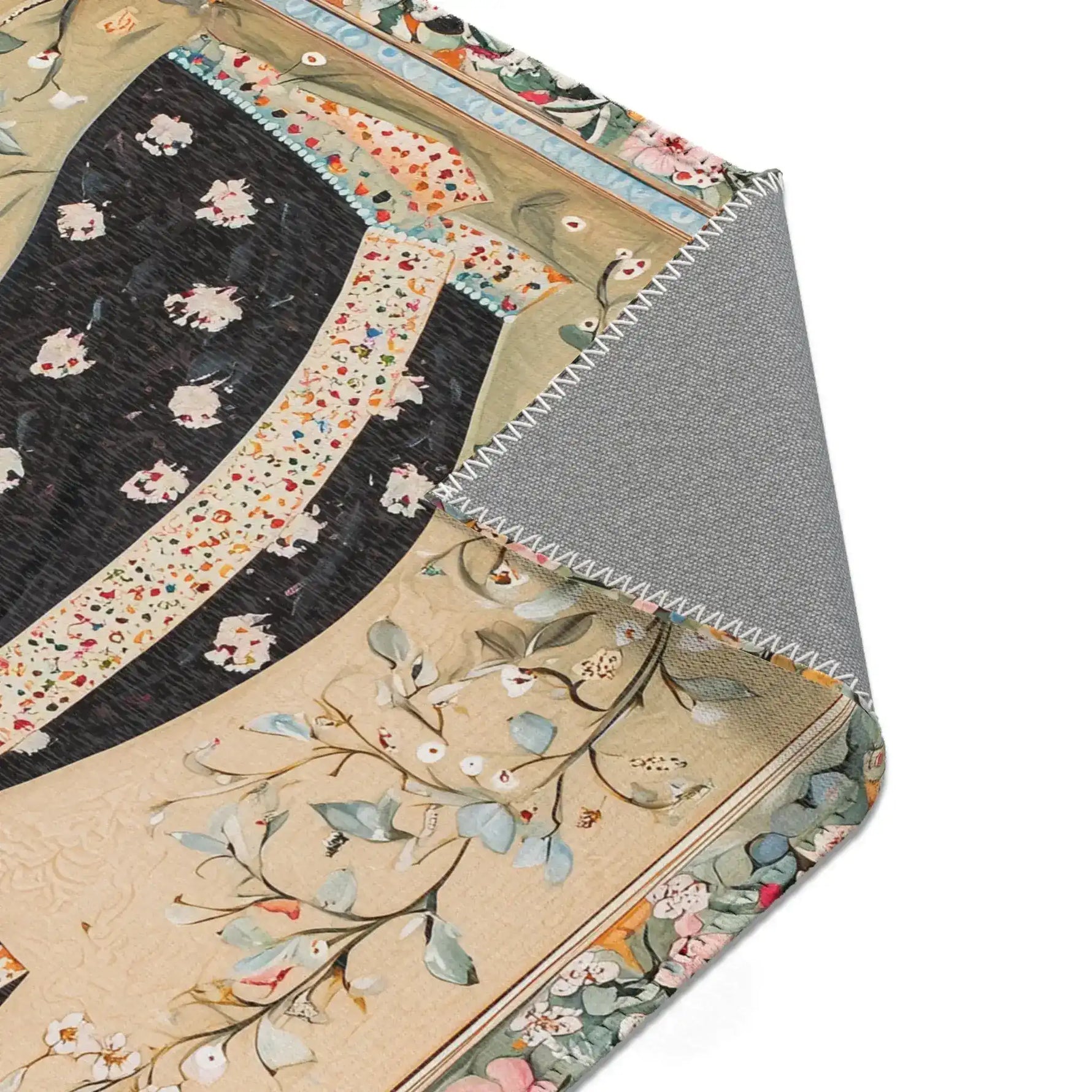 Hand-Painted Floral Rug - Close-up corner fold showing printed textile surface in black and cream botanical pattern with grey non-slip backing