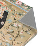 Hand-Painted Floral Rug - Corner fold revealing sage green botanical white blossom print on khaki ground with grey non-slip backing