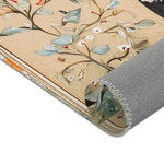 Hand-Painted Floral Rug - Rolled corner detail with blue-grey leaf print on cream ground, grey non-slip backing with decorative edge stitch