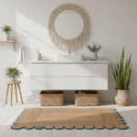 Modern bathroom with white vanity, round mirror, jute rug, and decorative elements.
