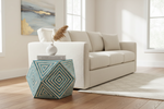 Handmade bone inlay hexagon side table with a teal and white concentric diamond pattern by a sofa.