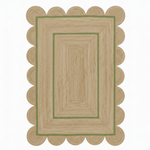 Rectangular jute rug with scalloped edge on a white background