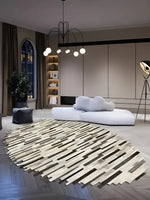 Stylish living room featuring a Handmade Irregular Oval Cowhide Rug as the centerpiece. This unique area rug, perfect for rugs for living room, adds a modern touch to the space. The 8x10 living room rug beautifully complements the contemporary decor with its distinctive design.