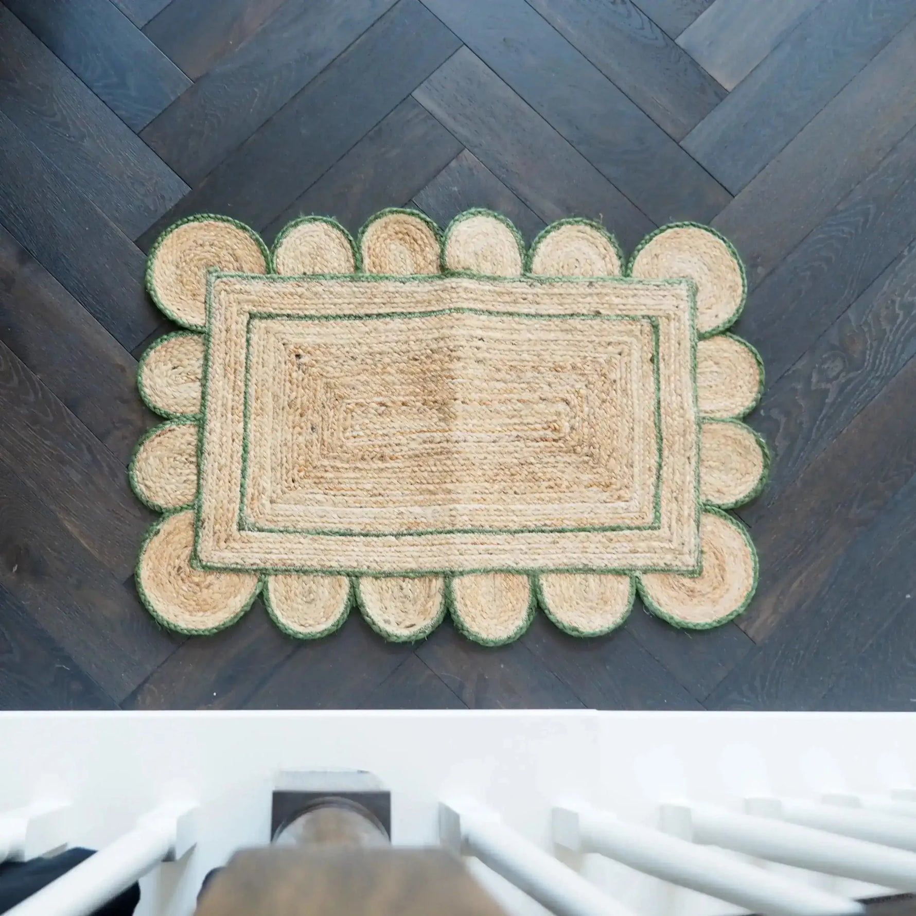 Top view of a handmade olive green scalloped border jute rug measuring 4 x 6 ft, perfect for enhancing your living room or kitchen space. This area rug features a unique scalloped design, ideal as a kitchen runner rug or a hallway runner rug, bringing natural texture and style to any large area.