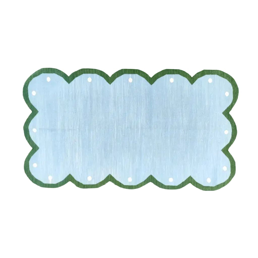 The "Handmade Scalloped Dotted Cotton Rug - 2' x 3'" features a charming scalloped edge and dotted pattern, offering a soft, durable, and stylish addition to any room.